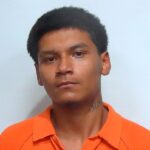 A man in an orange shirt