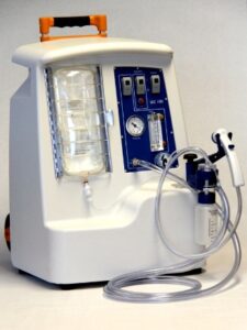 Portable medical suction machine with a clear canister, control panel, pressure gauge, tubing, and a handheld suction device attached, used for removing fluids from a patient’s airway or surgical site Portable medical suction machine with a clear canister, control panel, pressure gauge, tubing, and a handheld suction device attached, used for removing fluids from a patient’s airway or surgical site
