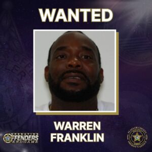 A “WANTED” poster featuring a man with a beard and mustache, identified as Warren Franklin, with logos for Operation Fenders Endgame and the LeFlore County Sheriff’s Office